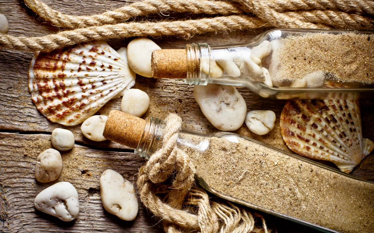 rope, bottle, sand, old wood, shell, stones