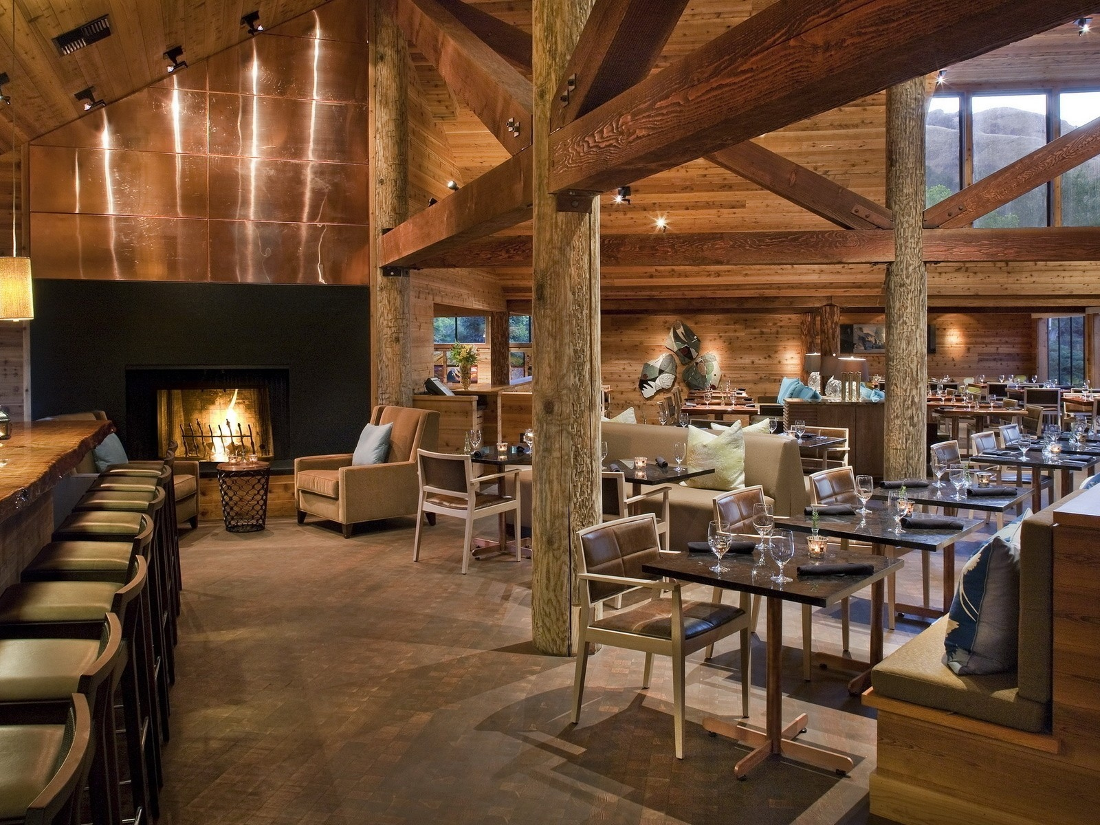 fireplace, chairs, bar, lights, tables, wine glasses, wood